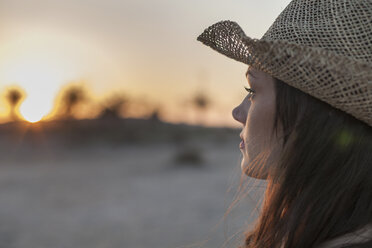 Portrait of woman wearing straw hat looking away - CUF01903