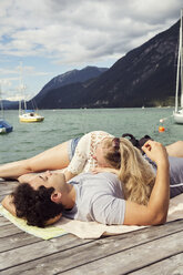 Couple lying together on pier, Innsbruck, Tirol, Austria, Europe - CUF01928