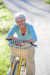 Portrait of senior woman on bicycle - CUF01937