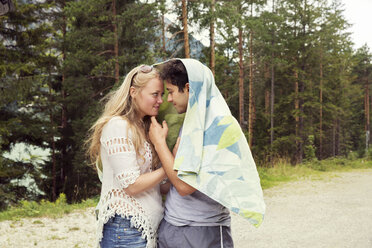 Couple wrapped in towel, face to face hugging - CUF01976