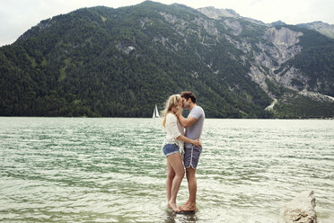 Couple in shallow water kissing, Achensee, Innsbruck, Tirol, Austria, Europe - CUF01981
