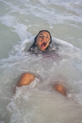 Junge Frau liegt lachend im Meer, Tulum, Quintana Roo, Mexiko - CUF02216