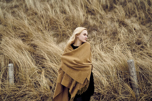 Fashionable young woman wearing light brown cape - MMIF00012