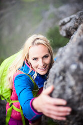 Austria, Salzburg State, Filzmoos, Female hiker climbing on rock - HHF05546