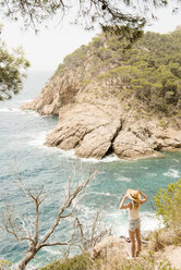 Woman along coastline, looking at view, elevated view, Tossa de mar, Catalonia, Spain - CUF02546