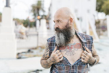 Mature male hipster revealing tattooed chest - CUF02676