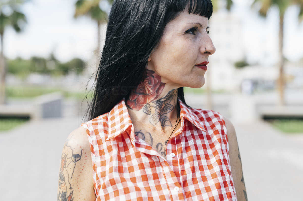 Mature female hipster with tattooed neck, close up stock photo