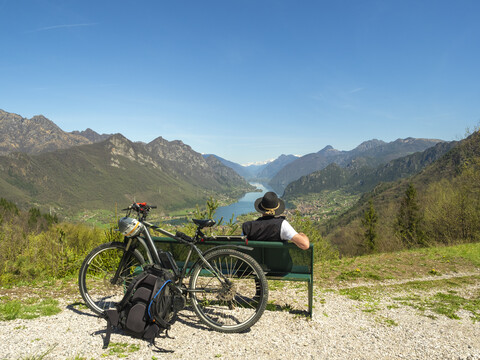 Italy, Lombardy, Senior hiker looking over Idro lake, Adamello Alps, Parco Naturale Adamello Brenta stock photo