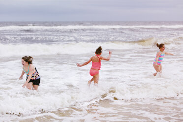 Drei Mädchen spielen in den Meereswellen, Dauphin Island, Alabama, USA - CUF02963