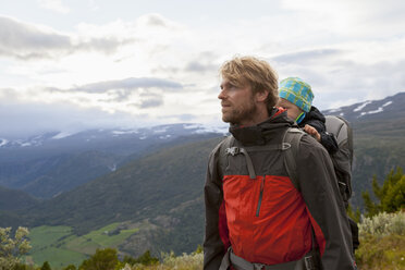Male hiker with son in mountain landscape, Jotunheimen National Park, Lom, Oppland, Norway - CUF03003