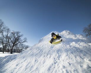 Boy sledding on snow - CUF03181