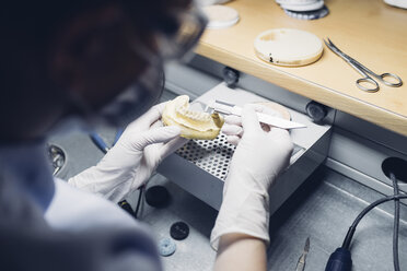 Dentist making denture in laboratory - CUF03367