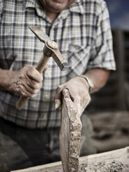 Stonemason working on stone with a hammer - CVF00452