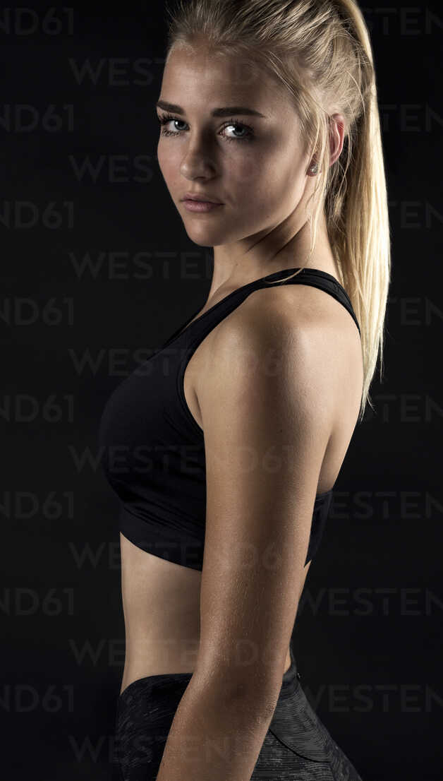 Portrait of teenage girl wearing sports clothing, studio shot stock photo