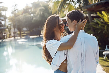 Romantic young couple embracing at poolside, Koh Samui, Thailand - CUF03993