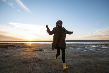 Woman enjoying beach at sunset - CUF04120