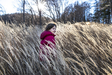 Young boy playing in tall grass - CUF04396