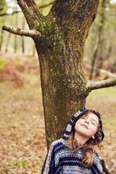 Young girl, leaning against tree, eyes closed - CUF04479