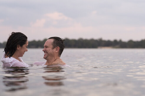 Clothed couple in water, Destin, Florida, United States, North America - ISF00943