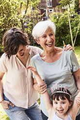 Portrait of senior woman with grown daughter and granddaughter, outdoors, laughing - ISF01117