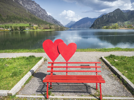 Italy, Lombardy, Idro lake, Adamello Alps, Parco Naturale Adamello Brenta, red bench with hearts - LAF02031