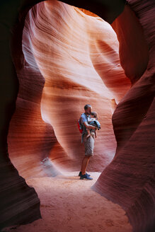 USA, Arizona, Father with baby on a baby carrier visiting Antelope Canyon - GEMF01961