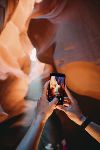 USA, Arizona, Mann fotografiert mit Handy im Antelope Canyon, lizenzfreies Stockfoto