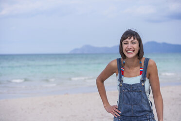 Woman laughing on the beach, Mallorca, Spain - CUF04668