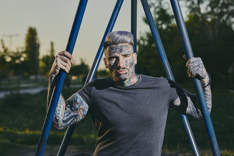 Portrait of tattooed young man outdoors stock photo