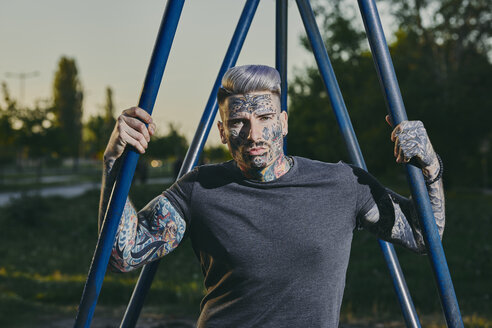 Portrait of tattooed young man outdoors - ZEDF01454