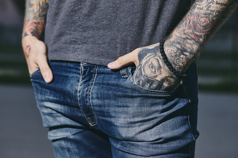 Tattooed arms of a young man outdoors stock photo