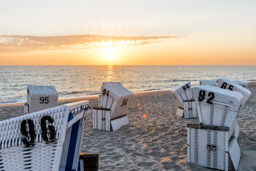 Germany, Schleswig-Holstein, Sylt, beach and empty hooded beach chairs at sunset - EGBF00251