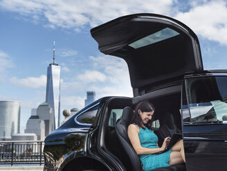 Geschäftsfrau mit digitalem Tablet im Auto, Jersey City, New Jersey, USA - ISF01229