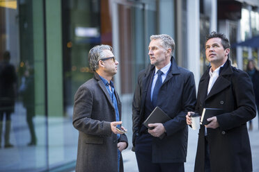 Businessmen talking in street - CUF04905