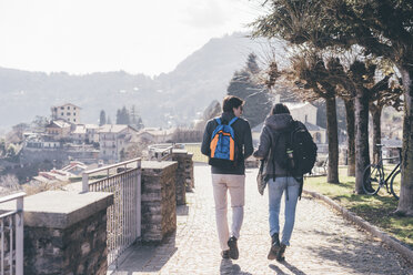 Rear view of couple strolling on terrace, Monte San Primo, Italy - CUF04987