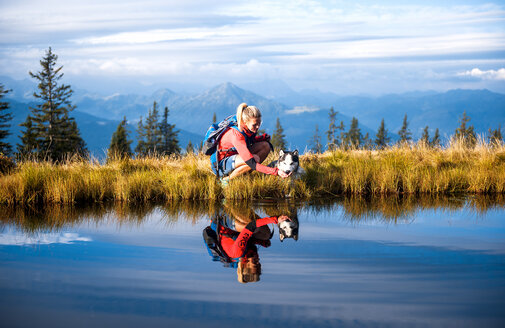 Austria, Salzburg State, female hiker with dog - HHF05566