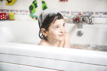 Boy sitting in bath, bubbles on head, smiling - CUF05105