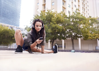 Dancer texting on mobile phone, Cape Town, South Africa - CUF05491