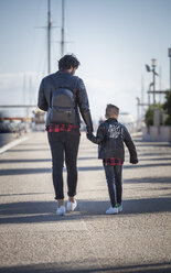 Father and son walking outdoors, holding hands, rear view - ISF01318