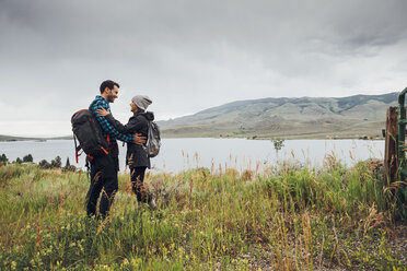 Couple standing beside Dillon Reservoir, face to face, Silverthorne, Colorado, USA - ISF01348
