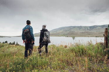 Couple near Dillon Reservoir, looking at view, Silverthorne, Colorado, USA - ISF01350