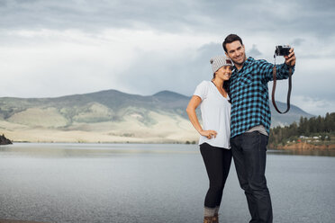Couple beside Dillon Reservoir, taking selfie, using camera, Silverthorne, Colorado, USA - ISF01355