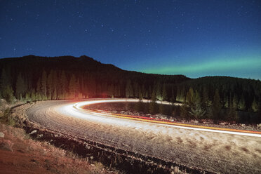 Northern lights, and long exposure light trails from vehicles on road, Nickel Plate Provincial Park, Penticton, British Columbia, Canada - ISF01370