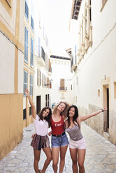 Spanien, Mallorca, Palma, Porträt von drei glücklichen jungen Frauen in der Stadt - IGGF00471