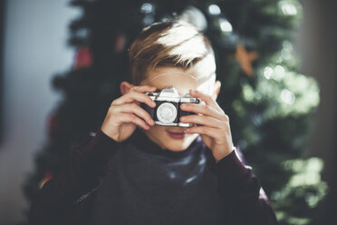 Junge beim Fotografieren, Weihnachtsbaum im Hintergrund - ISF01395