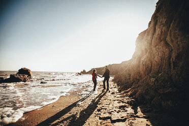 Mid adult couple holding hands on sunlit beach, Odessa Oblast, Ukraine - ISF01419