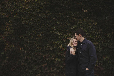 Portrait of mid adult couple, outdoors, hugging - ISF01453