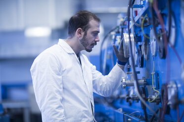 Scientist inspecting heavy machinery - CUF05794