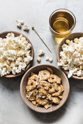 Bowls of popcorn, pretzel crackers and drink, overhead view - CUF06258