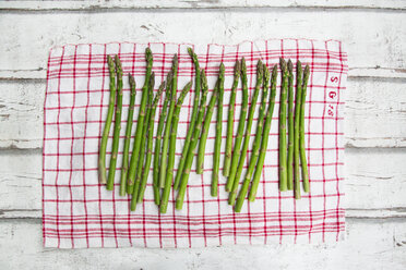 Organic green asparagus on red-white kitchen towel - LVF06971